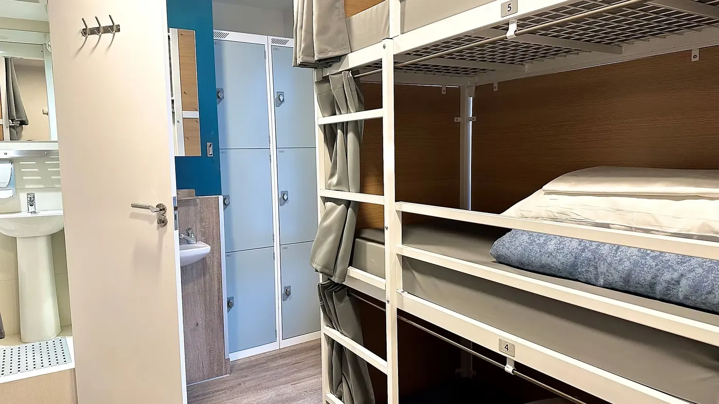 Dorm room with pod bunks and lockers