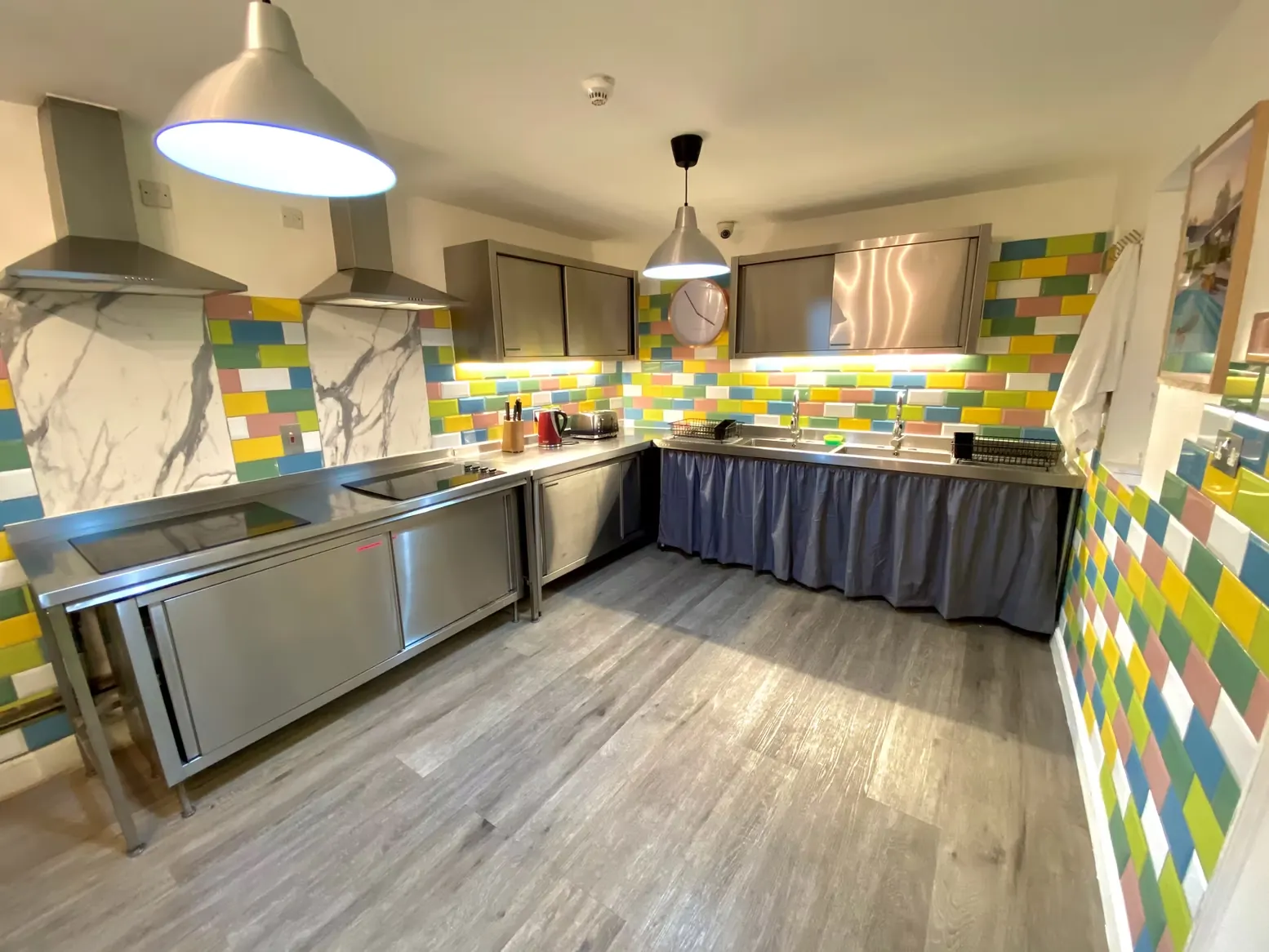 Self-catering kitchen with colourful tiled walls