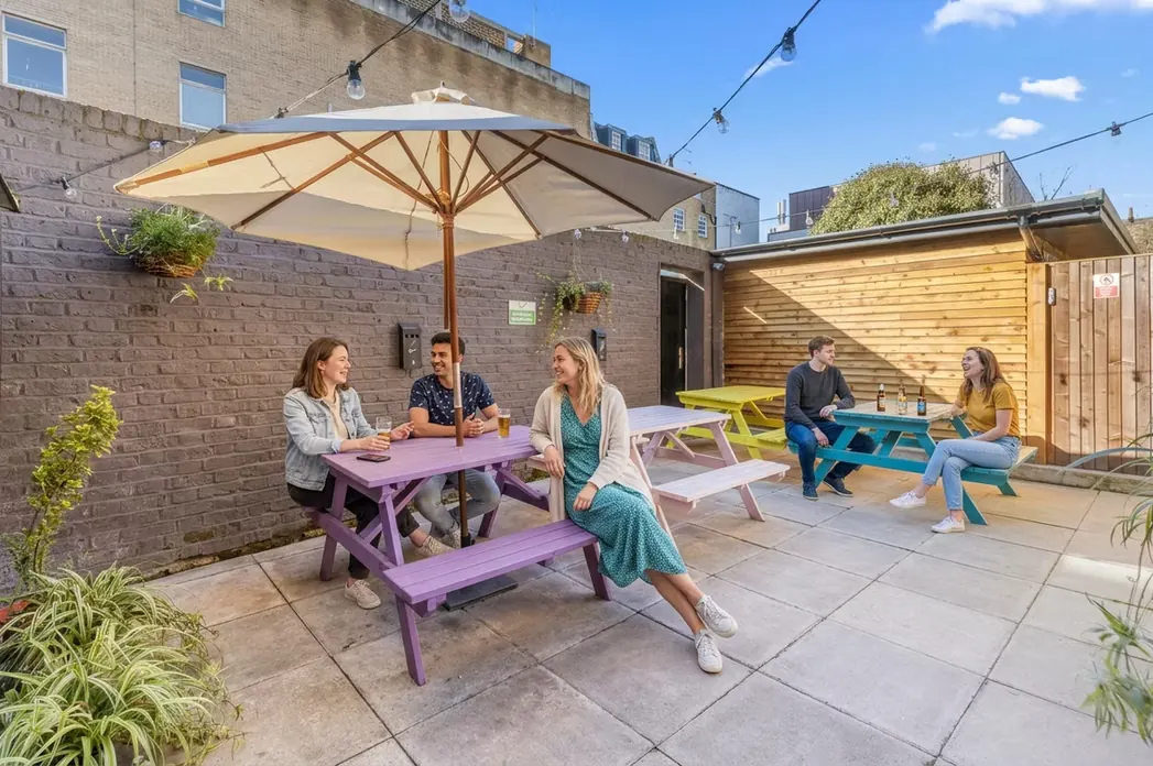 Outdoor terrace with picnic tables and parasol
